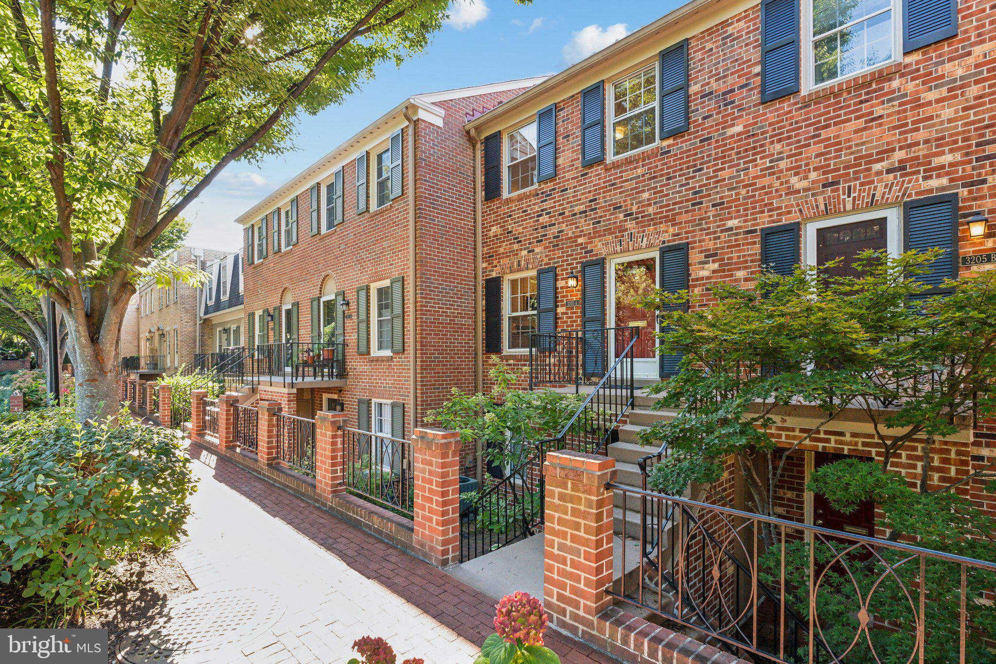 a view of a brick building next to a yard