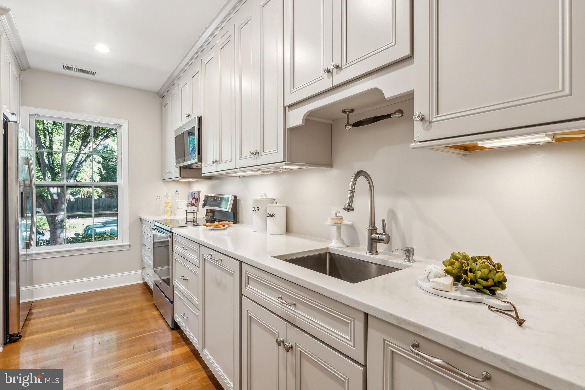 3205 Sutton Place Northwest, Unit A Washington, DC 20016 - Photo 14 of 44 a kitchen with a sink and cabinets