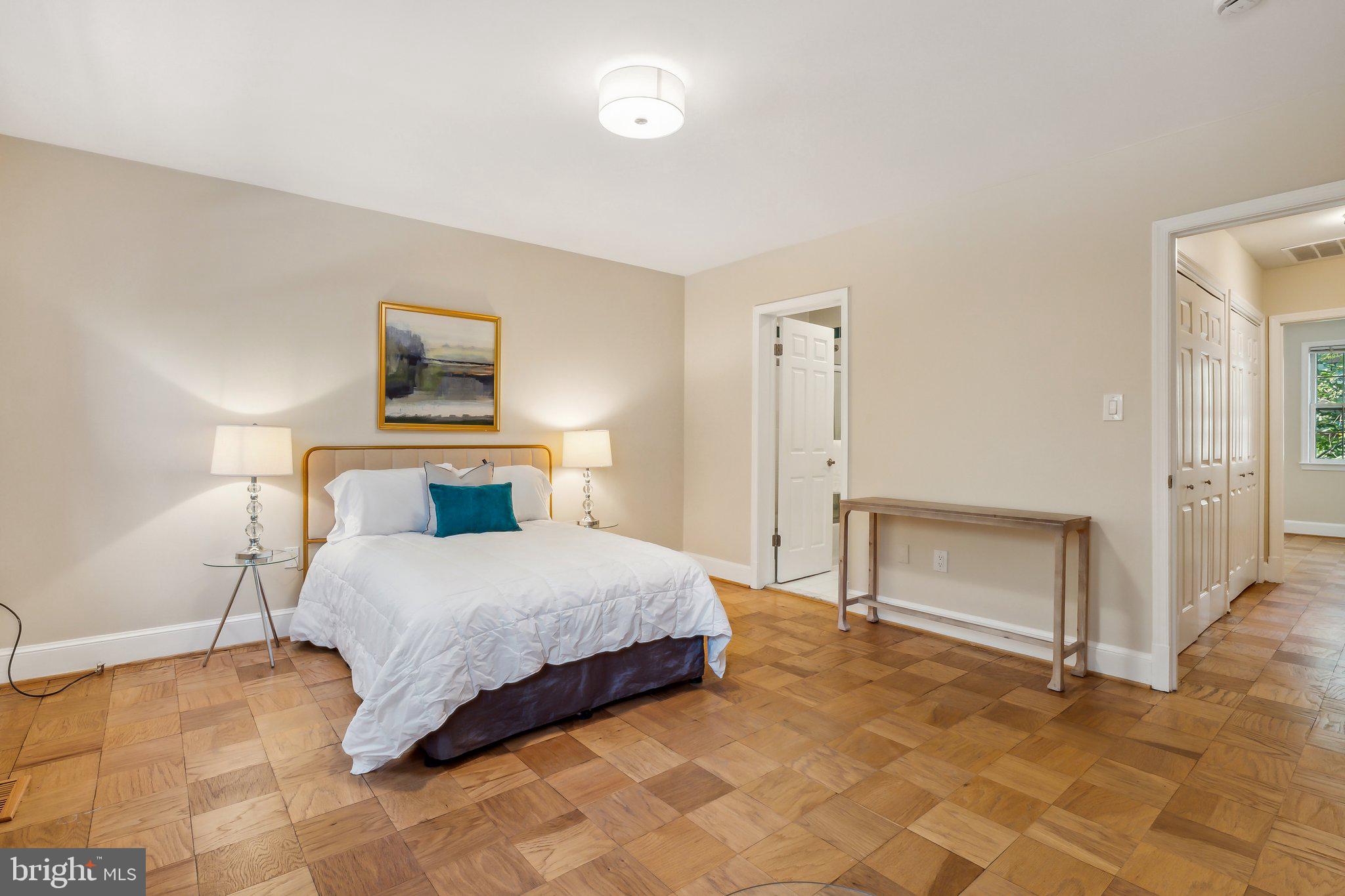 3205 Sutton Place Northwest, Unit A Washington, DC 20016 - Photo 19 of 44 a bedroom with a bed and a painting on the wall