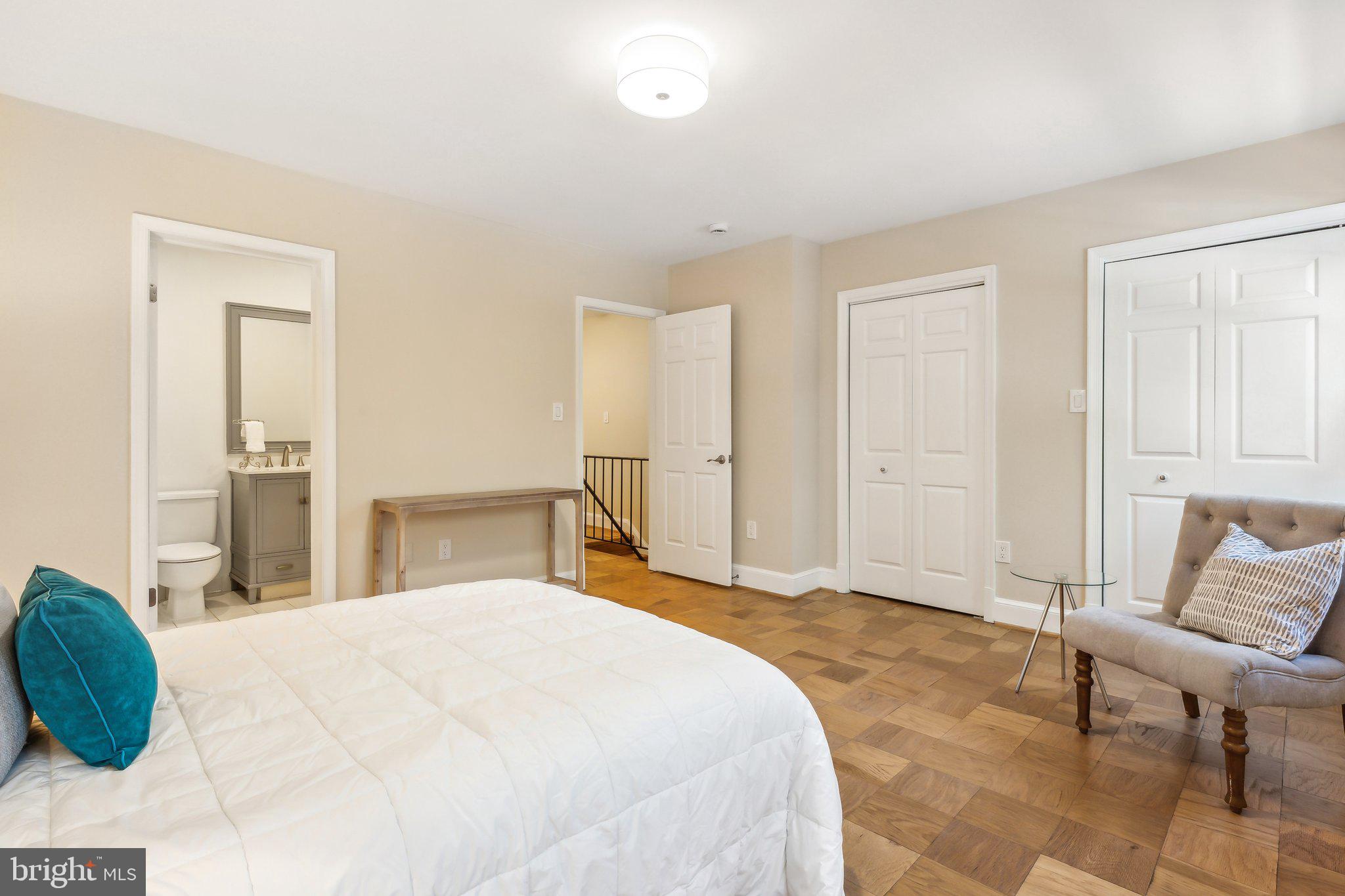 3205 Sutton Place Northwest, Unit A Washington, DC 20016 - Photo 22 of 44 a bedroom with a bed and chair
