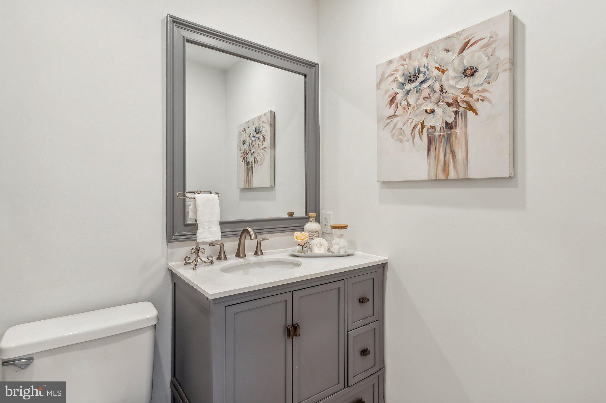 3205 Sutton Place Northwest, Unit A Washington, DC 20016 - Photo 24 of 44 a bathroom with a toilet sink and mirror