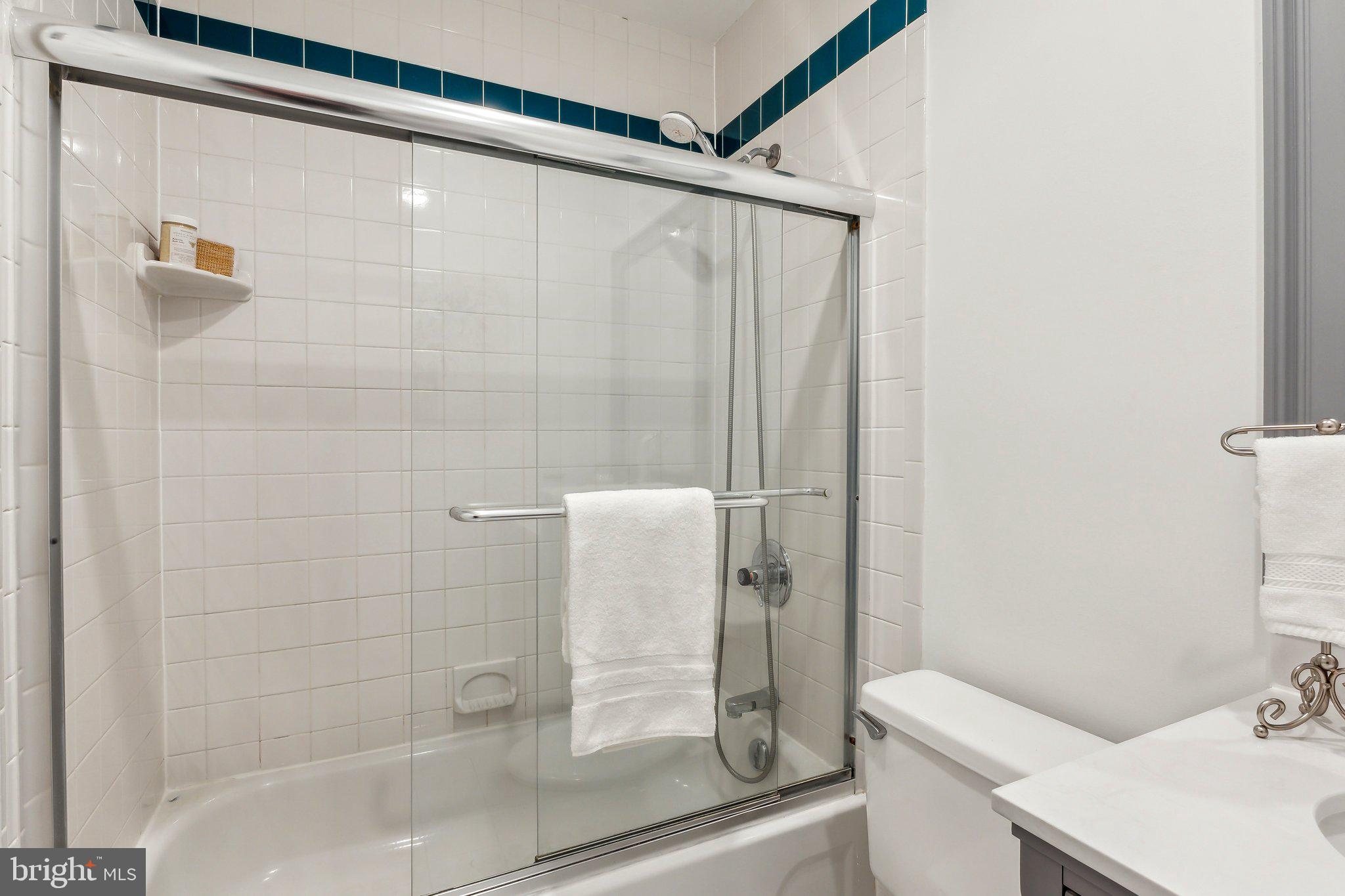 3205 Sutton Place Northwest, Unit A Washington, DC 20016 - Photo 25 of 44 a bathroom with a shower and a sink