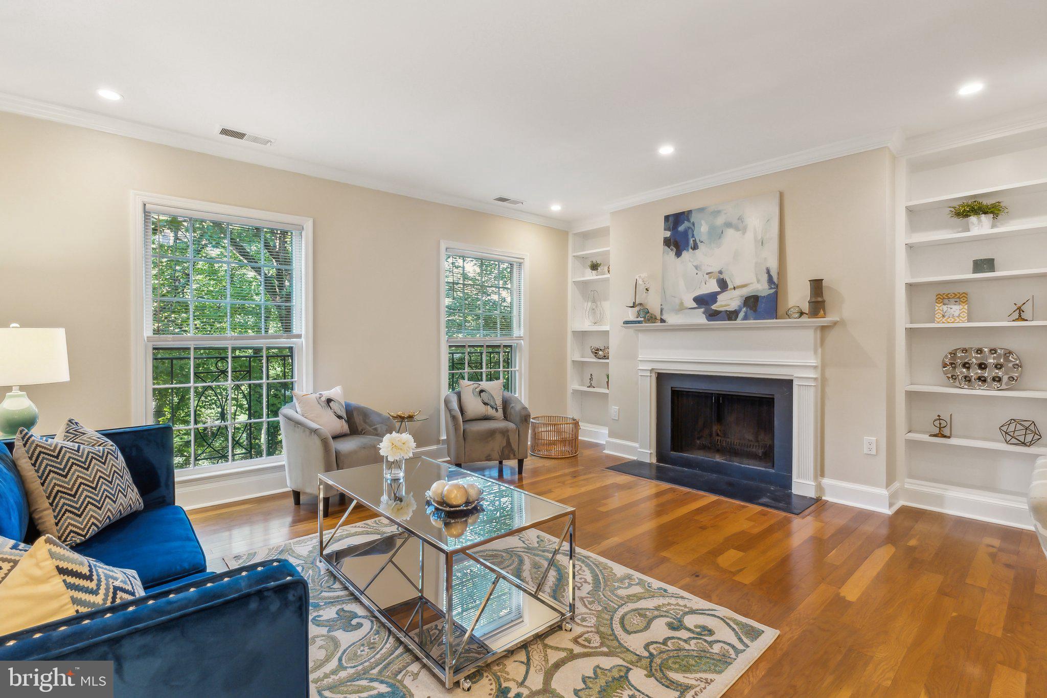 3205 Sutton Place Northwest, Unit A Washington, DC 20016 - Photo 3 of 44 a living room with furniture and a fireplace