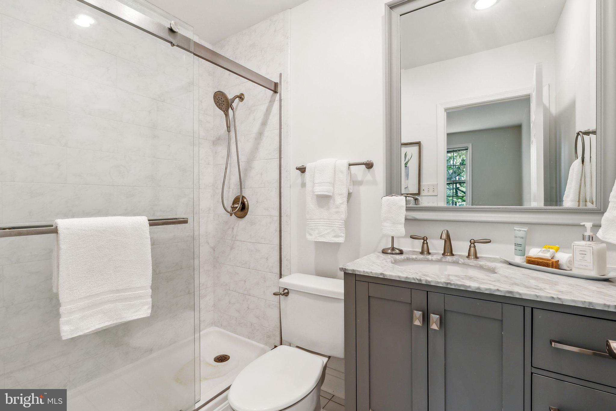 3205 Sutton Place Northwest, Unit A Washington, DC 20016 - Photo 31 of 44 a bathroom with a sink toilet tub and shower