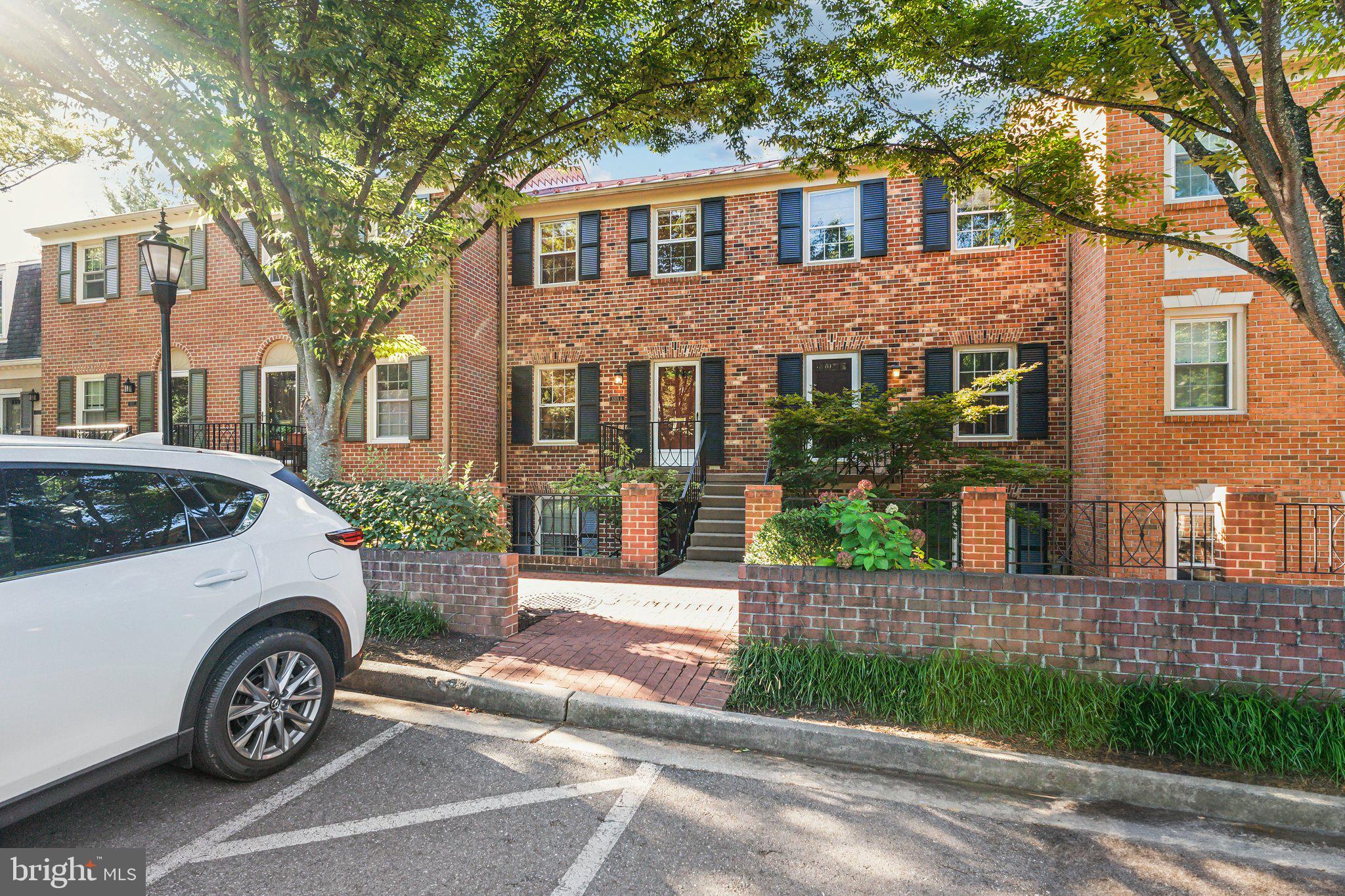 3205 Sutton Place Northwest, Unit A Washington, DC 20016 - Photo 40 of 44 a front view of a house with a garden