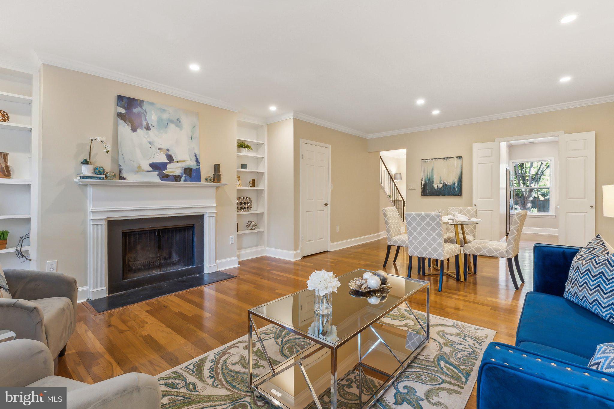 3205 Sutton Place Northwest, Unit A Washington, DC 20016 - Photo 5 of 44 a living room with furniture and a fireplace