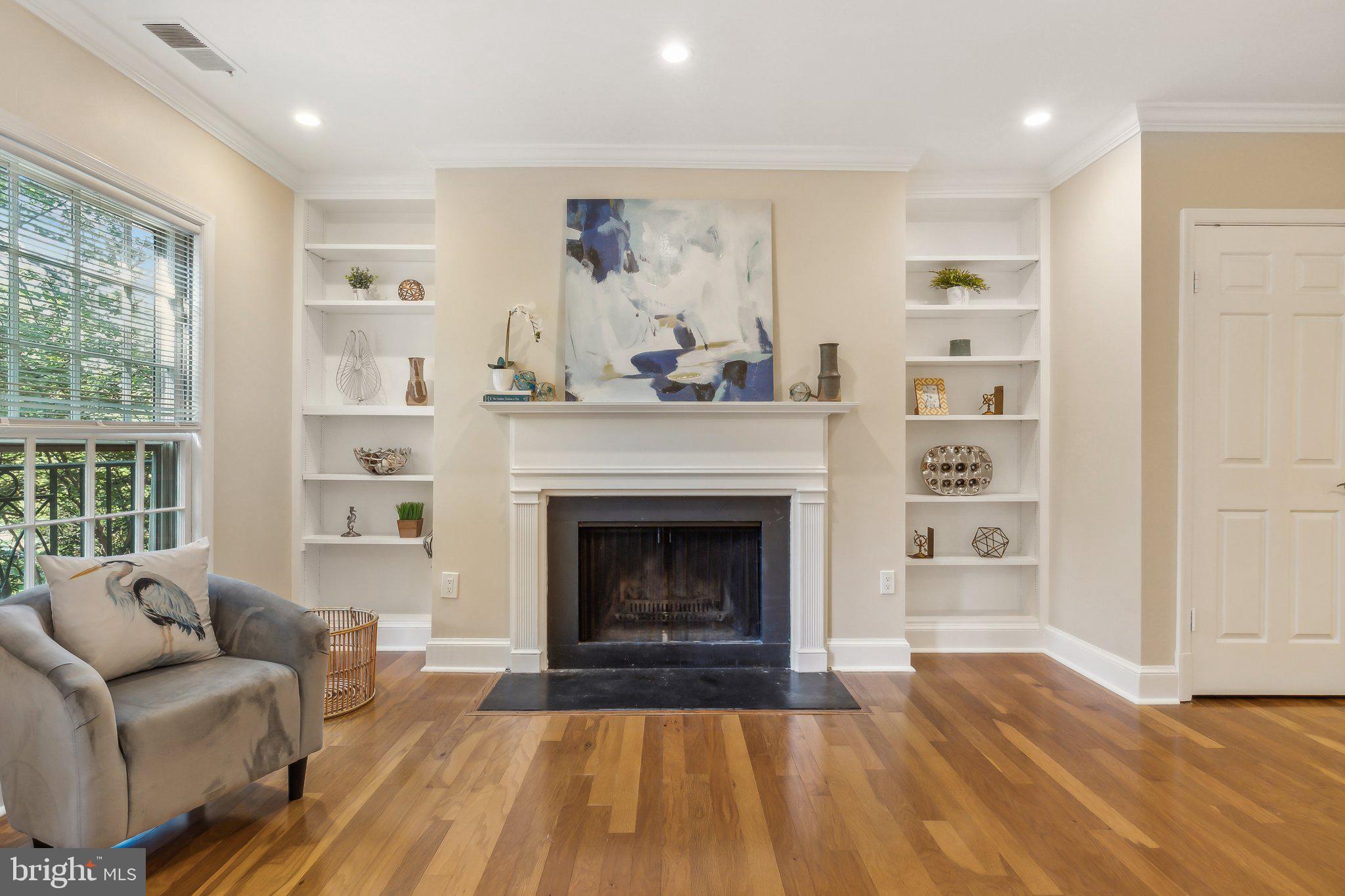 3205 Sutton Place Northwest, Unit A Washington, DC 20016 - Photo 7 of 44 a living room with furniture and a fireplace