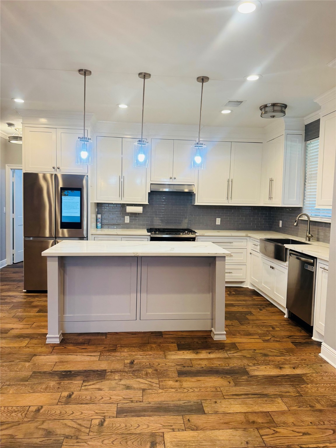 5317 Higgins Street Houston, TX 77033 - Photo 2 of 50 a kitchen with kitchen island granite countertop a stove a sink and a refrigerator