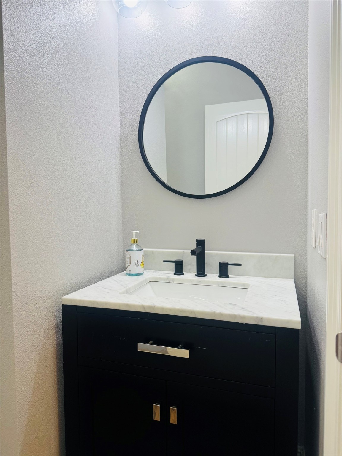 5317 Higgins Street Houston, TX 77033 - Photo 25 of 50 a bathroom with a sink and a mirror