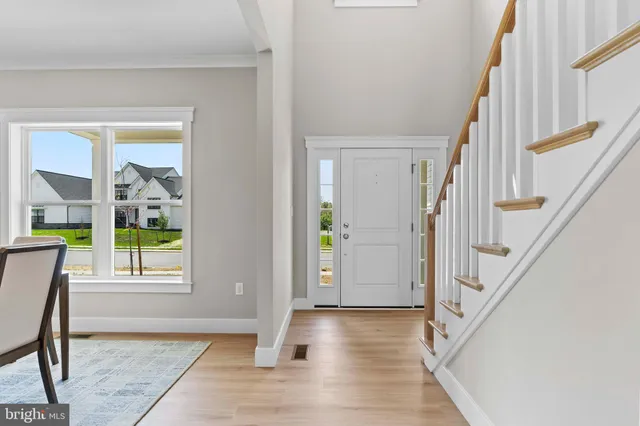 a view of an entryway with wooden floor and door