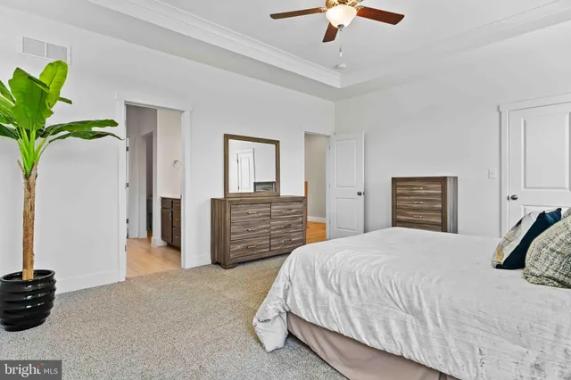 a bedroom with a bed and ceiling fan