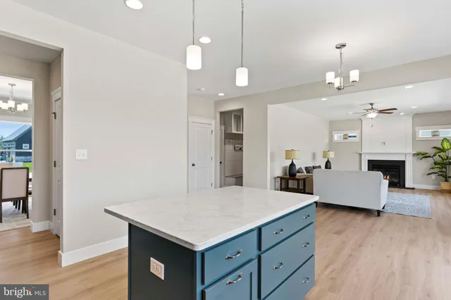 an open kitchen with a table and chandelier