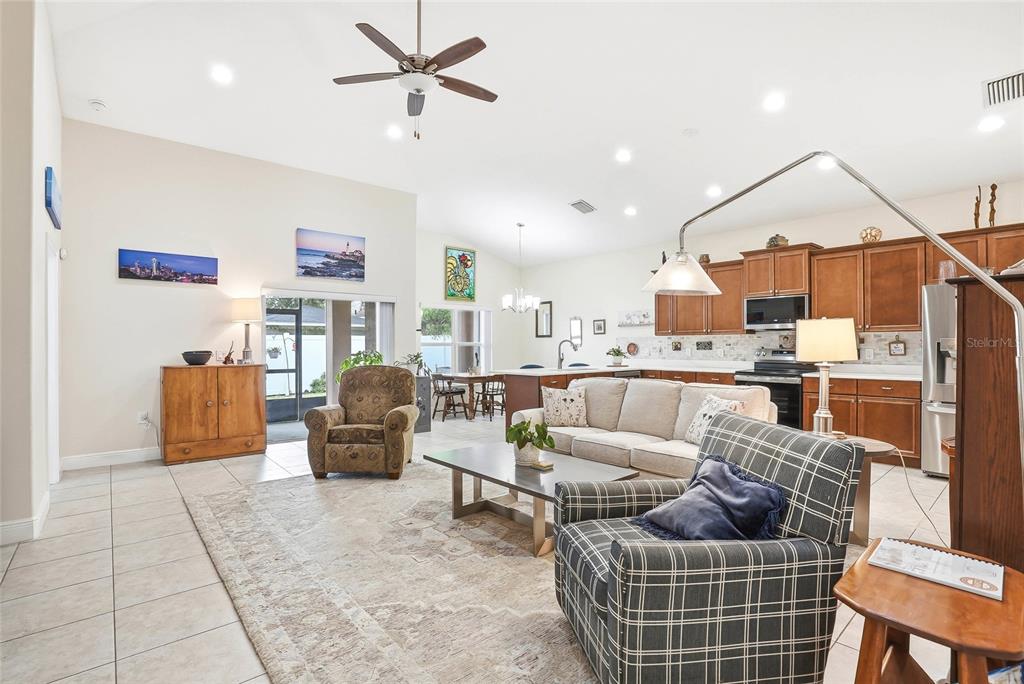 2906 West Douglas Street Tampa, FL 33607 - Photo 6 of 36 a living room with furniture a rug and kitchen view