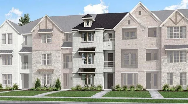 a front view of a residential apartment building with a yard