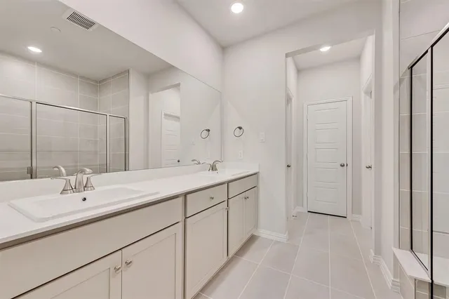a bathroom with 2 sink tub and a mirror