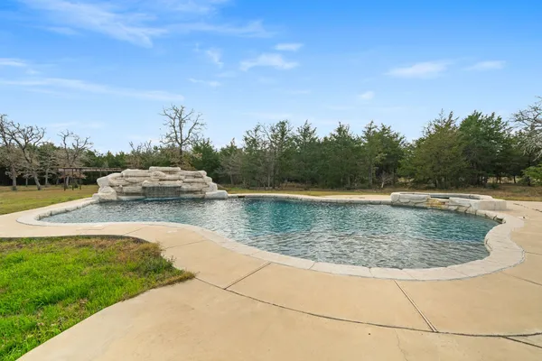 a view of a swimming pool with an outdoor space and seating area