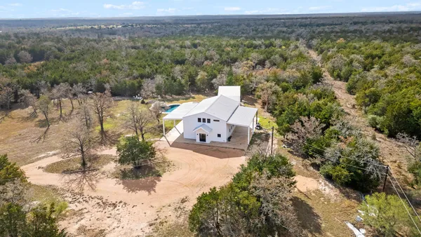 an aerial view of a house with a yard