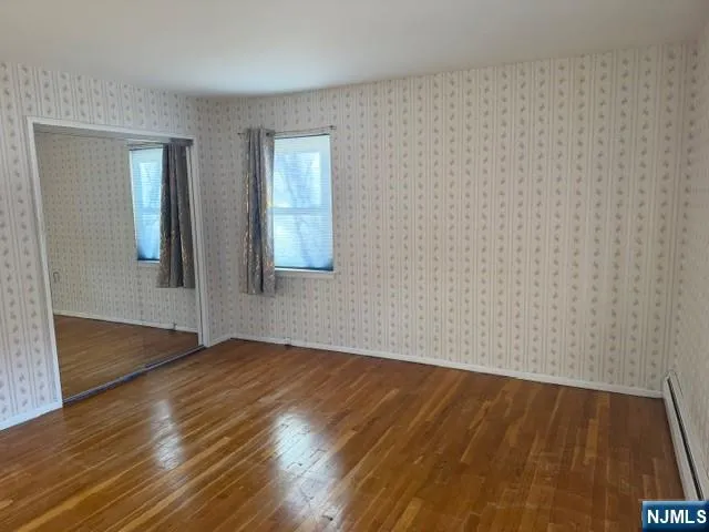 a view of small space with wooden floor and a window