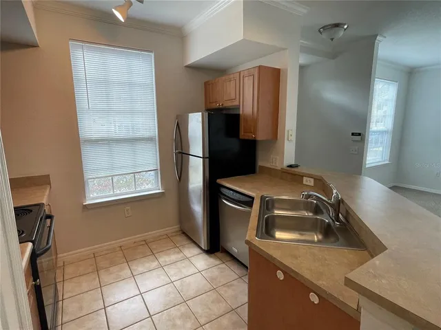 a kitchen with a refrigerator and a sink