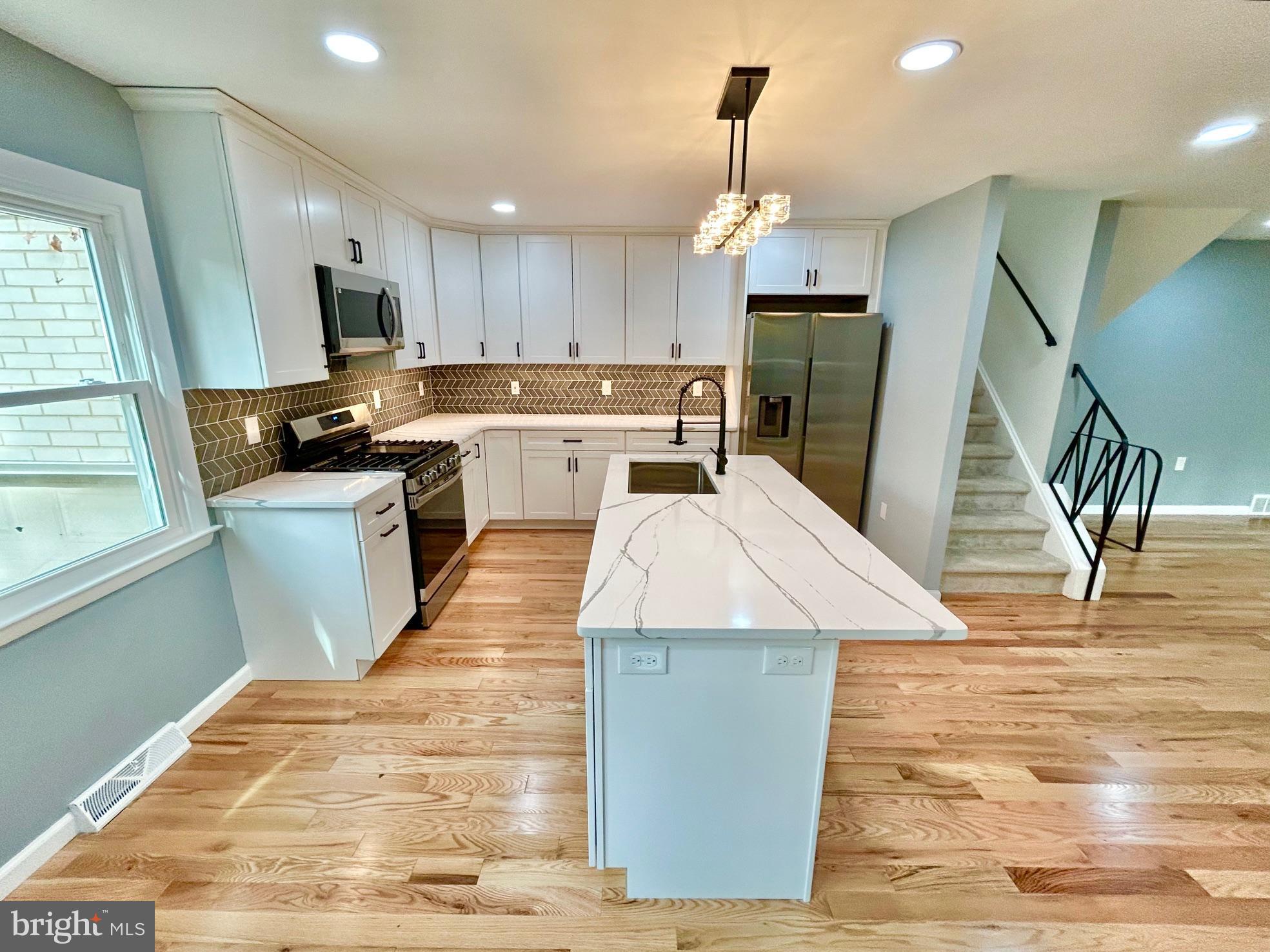 1224 Grinnell Road Wilmington, DE 19803 - Photo 17 of 48 a kitchen with stainless steel appliances granite countertop a sink stove and refrigerator