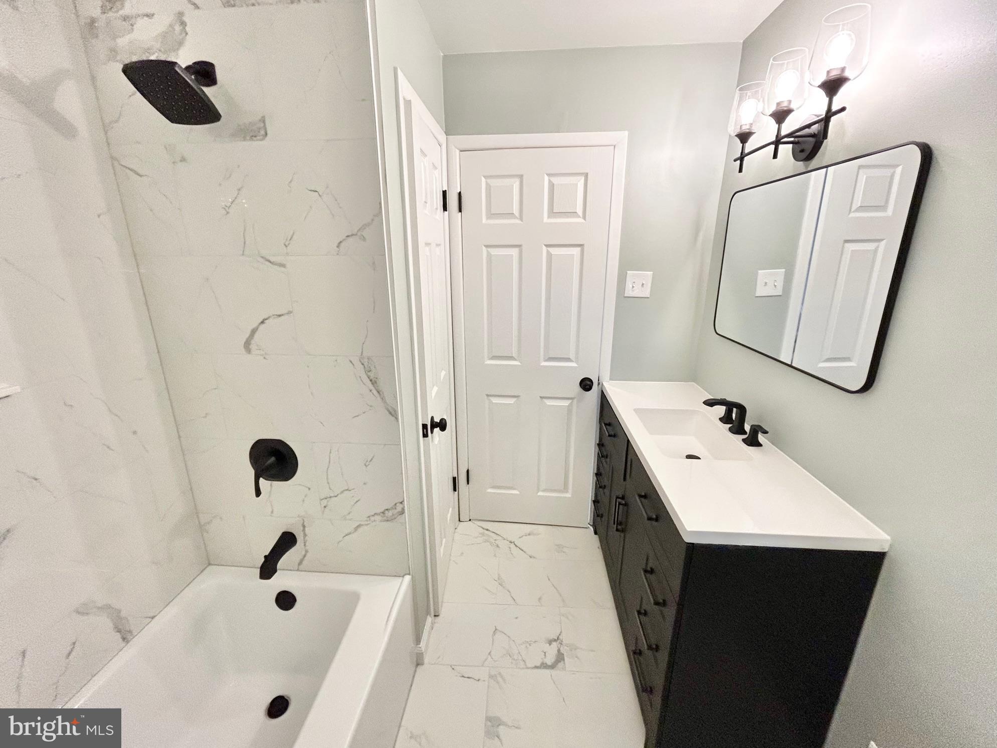 1224 Grinnell Road Wilmington, DE 19803 - Photo 19 of 48 a bathroom with a tub sink and mirror
