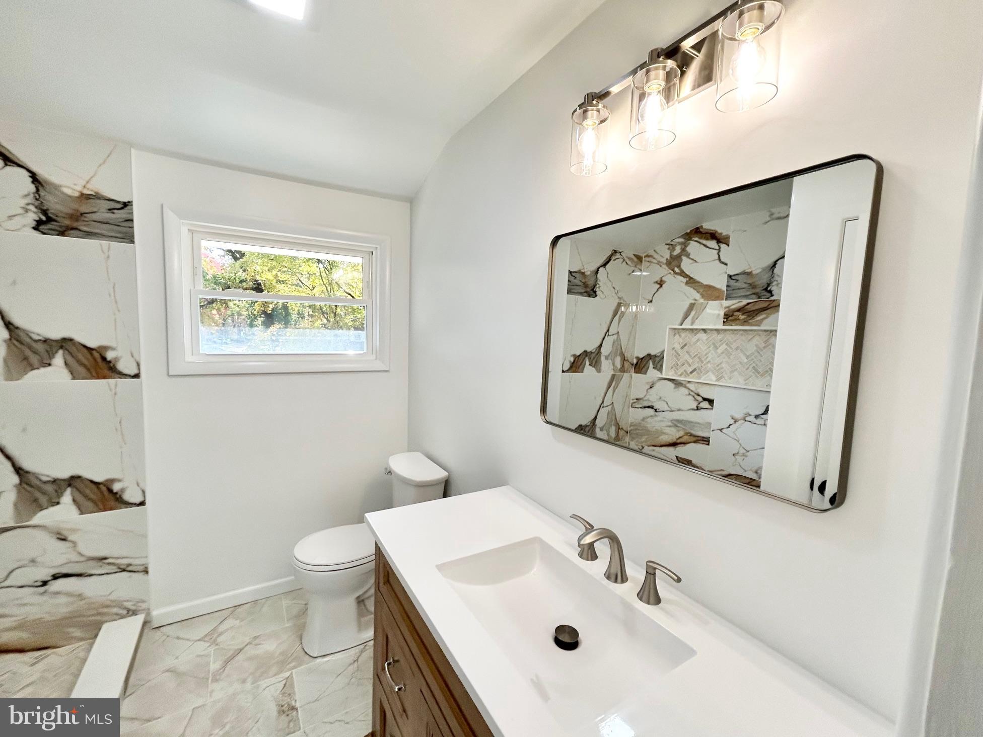 1224 Grinnell Road Wilmington, DE 19803 - Photo 34 of 48 a bathroom with a sink and a mirror