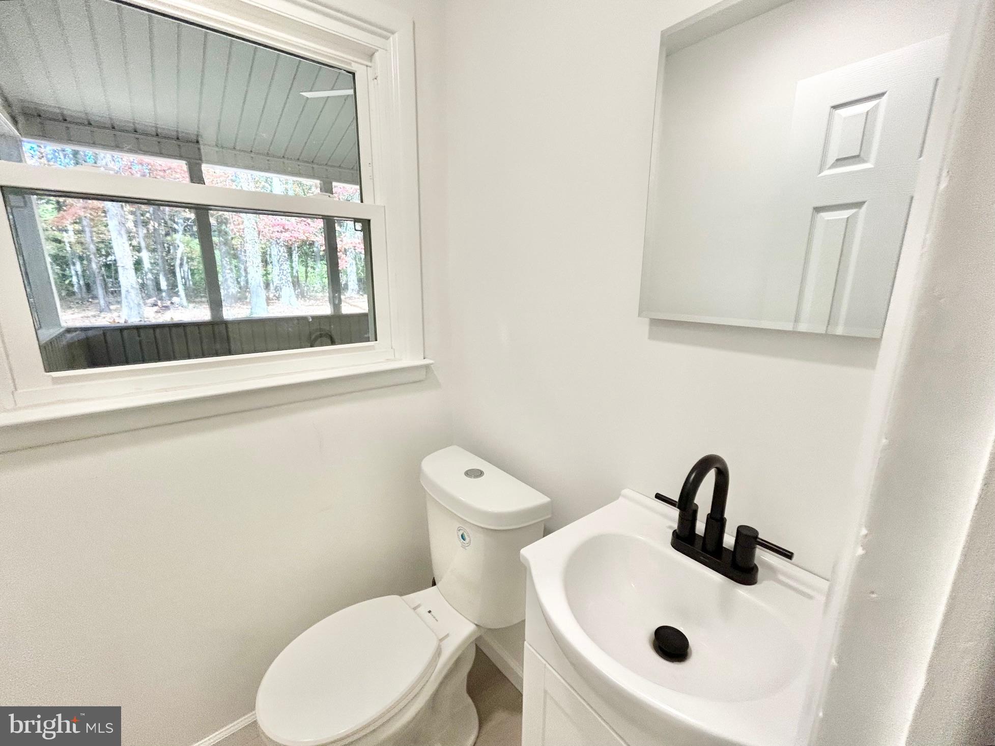 1224 Grinnell Road Wilmington, DE 19803 - Photo 7 of 48 a white toilet sitting next to a bathroom sink