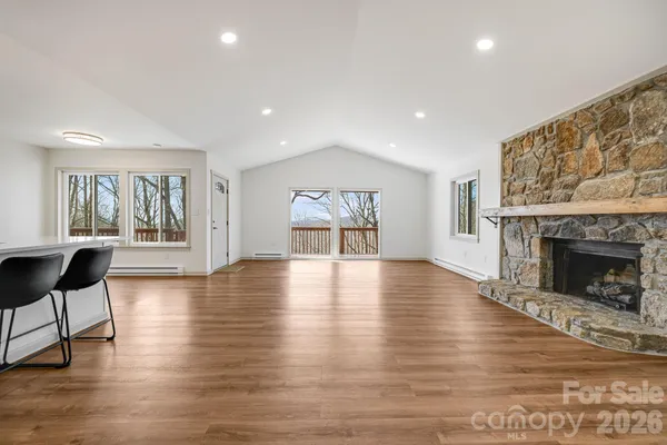 a kitchen with stainless steel appliances granite countertop a stove and wooden floor