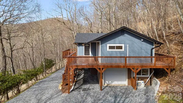 an empty room with wooden floor and fireplace