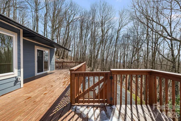 a large kitchen with granite countertop a large counter top stainless steel appliances and cabinets