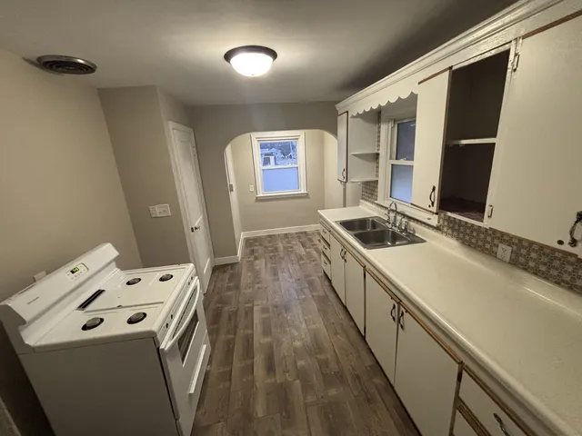 a kitchen that has a sink and a stove