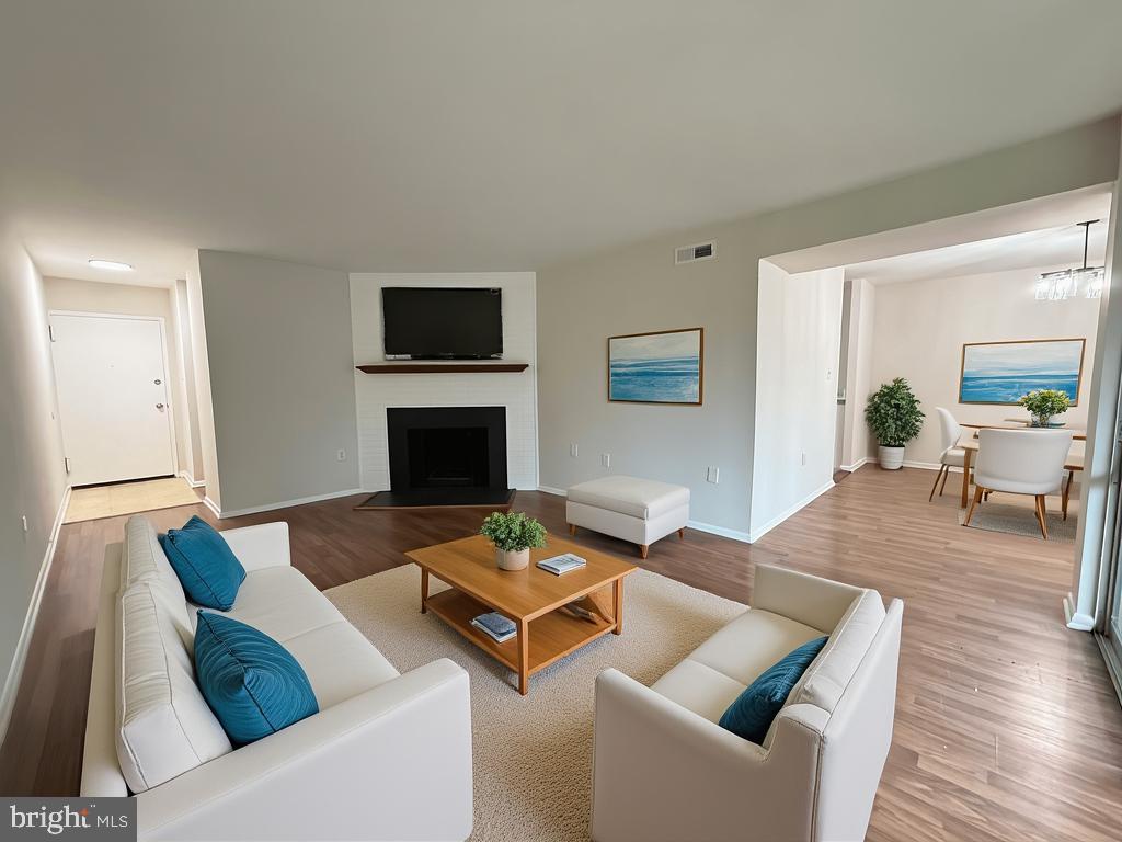 8689 Greenbelt Road, Unit 101 Greenbelt, MD 20770 - Photo 4 of 27 a living room with furniture and a fireplace