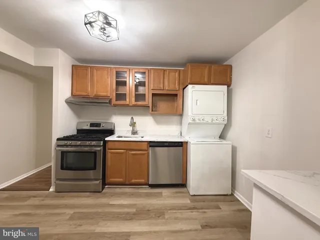 a kitchen with granite countertop a stove and a sink