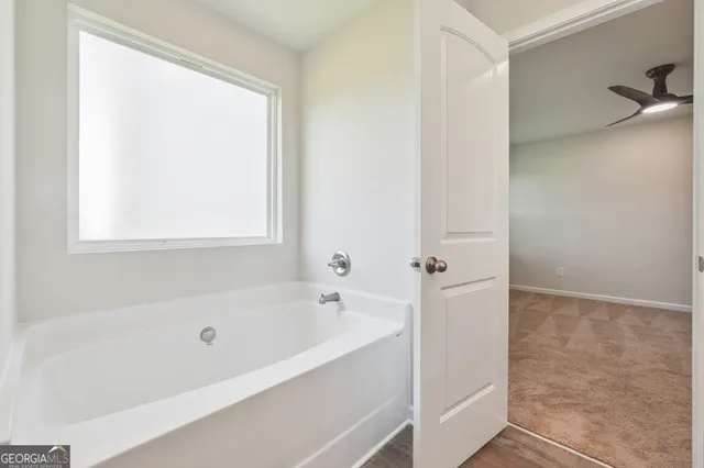 a white bath tub sitting next to a window