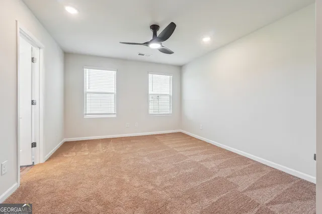 an empty room with windows and closet