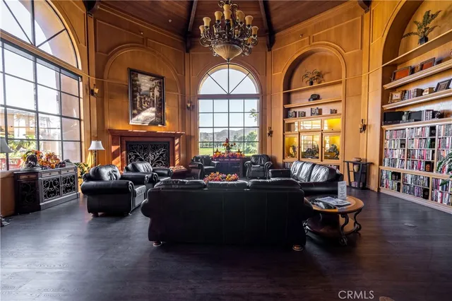 a room with wooden floor pool table and windows