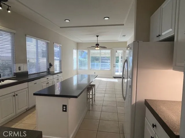 a kitchen with stainless steel appliances granite countertop a sink a stove and a refrigerator