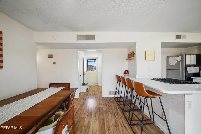 a view of a hallway with wooden floor and closet