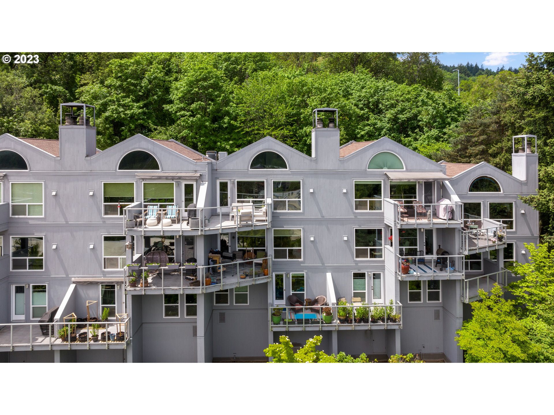 5411 Southwest View Point Terrace Portland, OR 97239 - Photo 1 of 44 a front view of a residential apartment building with a yard