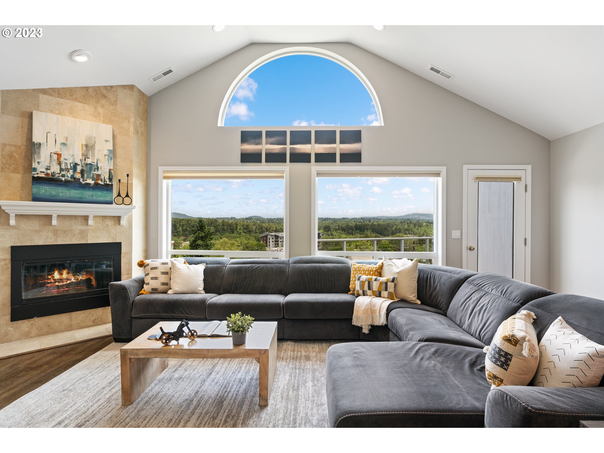 5411 Southwest View Point Terrace Portland, OR 97239 - Photo 13 of 44 a living room with furniture a large window and a fireplace