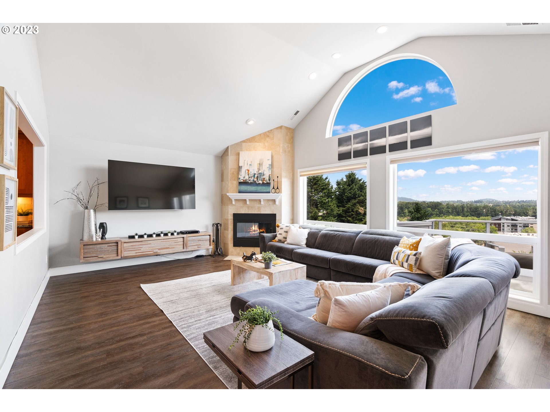 5411 Southwest View Point Terrace Portland, OR 97239 - Photo 14 of 44 a living room with furniture a flat screen tv and a large window