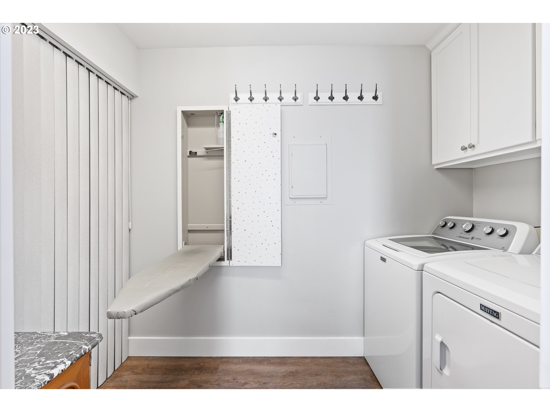 5411 Southwest View Point Terrace Portland, OR 97239 - Photo 25 of 44 a view of washer and dryer with kitchen in the background