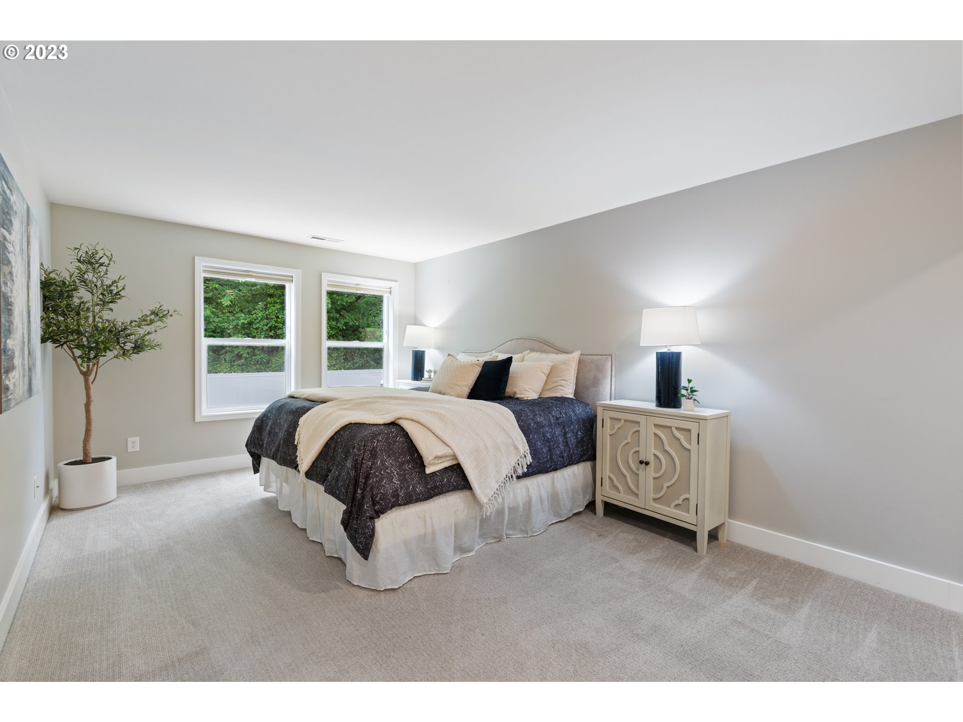 5411 Southwest View Point Terrace Portland, OR 97239 - Photo 29 of 44 a bedroom with a large bed and a large window