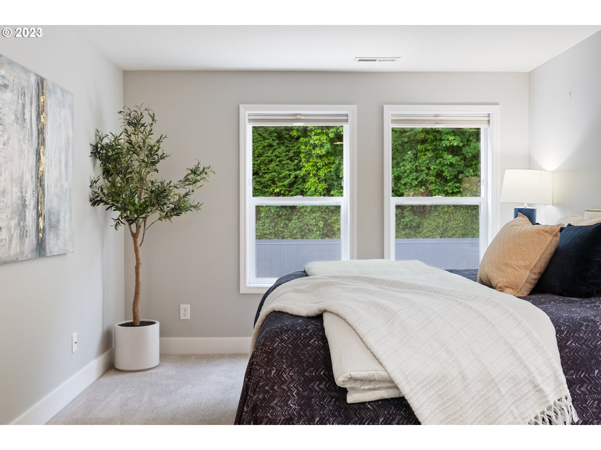 5411 Southwest View Point Terrace Portland, OR 97239 - Photo 30 of 44 a bedroom with a bed and a potted plant