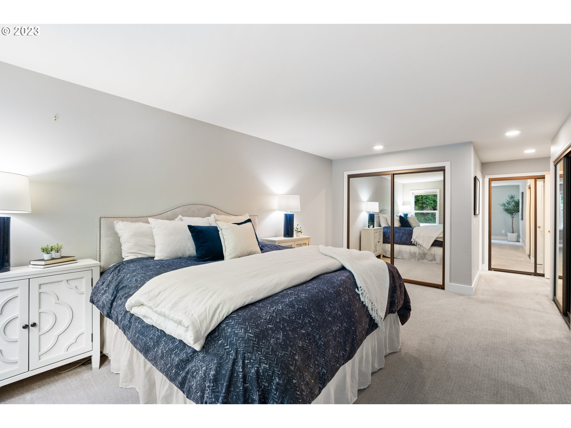 5411 Southwest View Point Terrace Portland, OR 97239 - Photo 31 of 44 a bed room with a bed a mirror and lamp
