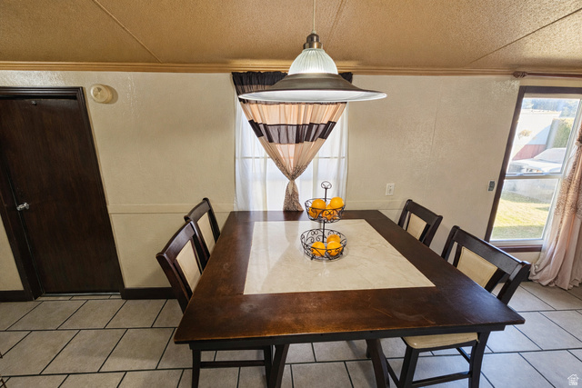 340 West 920 South, Unit 16 Provo, UT 84601 - Photo 6 of 15 Dining room with crown molding, light tile patterned flooring, and a textured ceiling