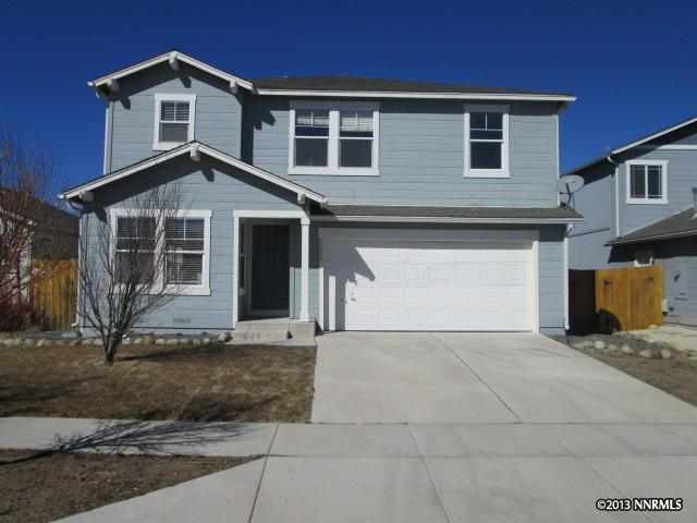 7875 Tulear Street Reno, NV 89506 - Photo 1 of 1 a front view of a house with a yard and garage