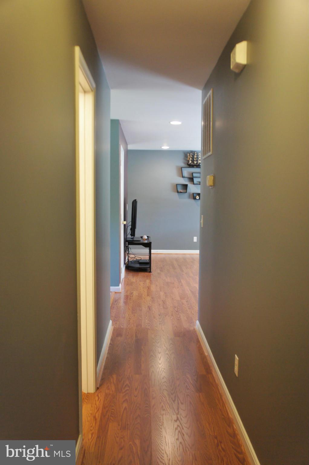 5015 Decatur Street St. Leonard, MD 20685 - Photo 14 of 30 a view of a hallway with wooden floor and staircase