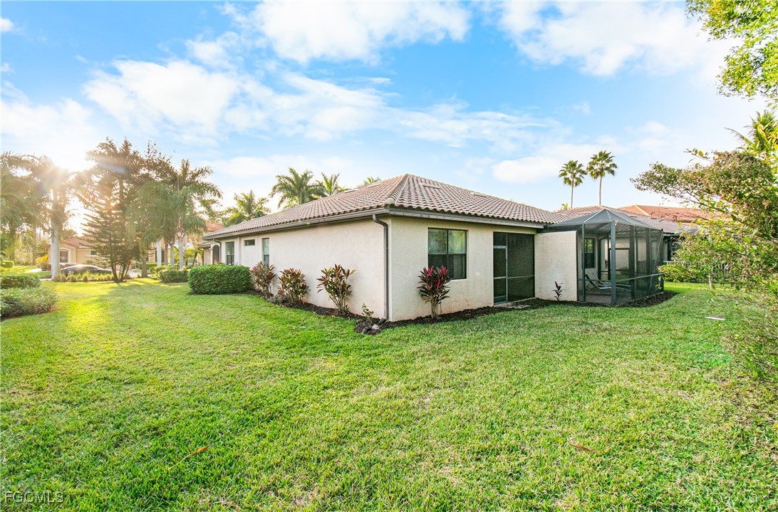 9101 Water Tupelo Road Fort Myers, FL 33912 - Photo 28 of 43 a view of a house with a yard