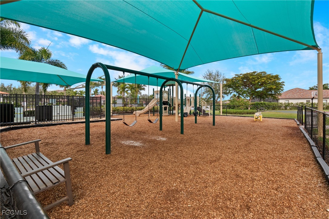 9101 Water Tupelo Road Fort Myers, FL 33912 - Photo 39 of 43 a view of a patio with a table and chairs under an umbrella